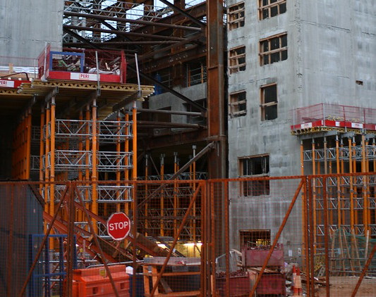 Construction workers on-site with tools, showcasing various roles like carpenters, electricians, and plumbers.